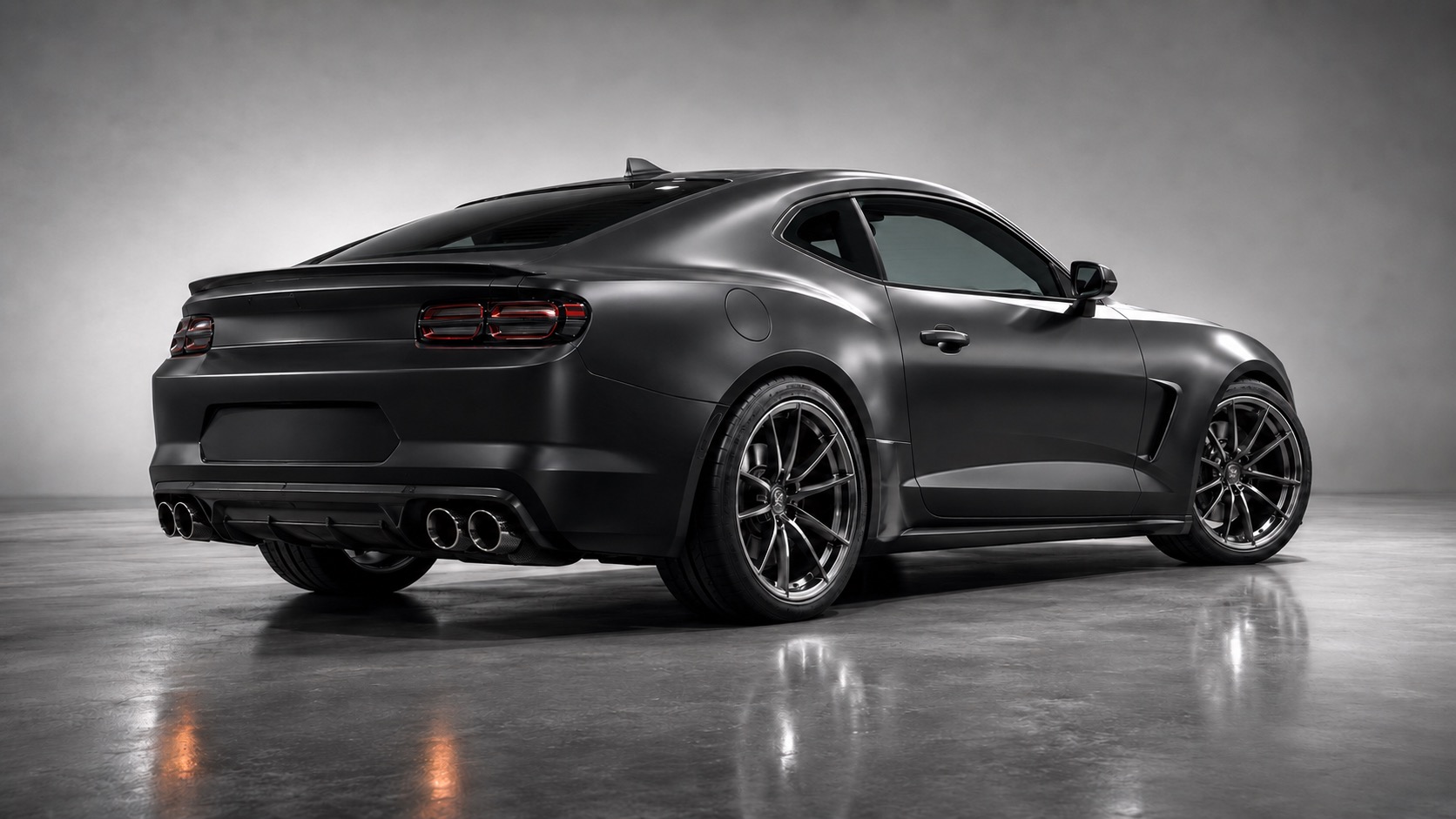 Matte-black Chevrolet Camaro, rear three-quarter view with quad exhaust tips and carbon rear diffuser